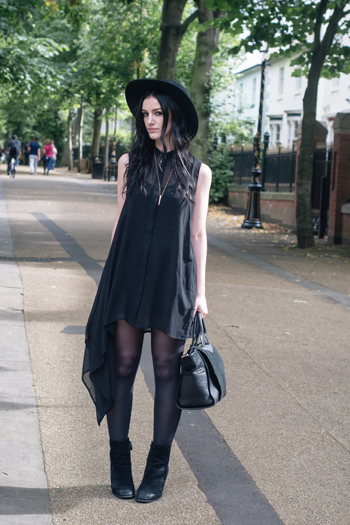 Fashion blogger Stephanie of FAIIINT wearing Catarzi wide brim fedora hat, H&M asymmetric chiffon shirt dress, H&M suede boots. All black everything goth dark street style outfit.