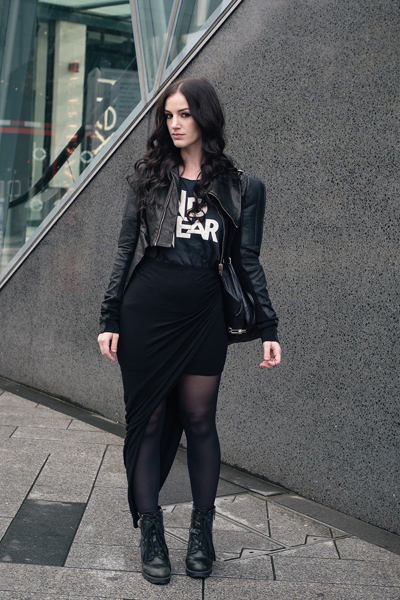 Fashion blogger Stephanie of FAIIINT wearing Rick Owens leather jacket, H&M tee, draped asymmetric skirt, ASH poker boots, Topshop backpack. All black everything street style outfit.