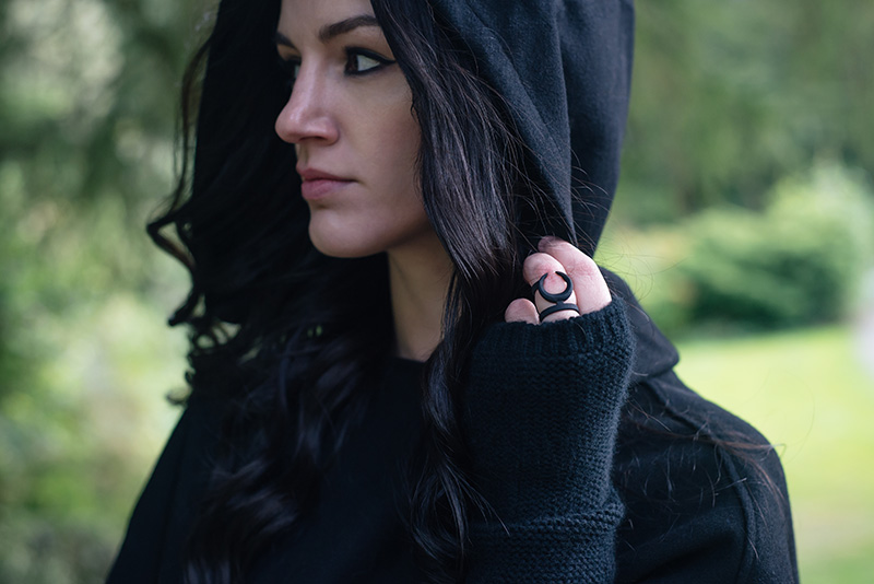 Fashion blogger Stephanie of FAIIINT wearing Necessary Evil Morrigan wool cape with hood, Black.co.uk cashmere wrist warmers, The Rogue + The Wolf Occult ring. All black gothic autumn outfit.