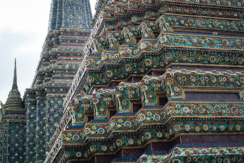 Temples of Bangkok Thailand, Wat Pho stupa mosaic details close up.