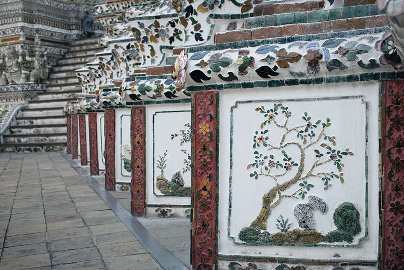 Temples of Bangkok Thailand, Wat Arun the Temple of Dawn close up of mosaic detail.
