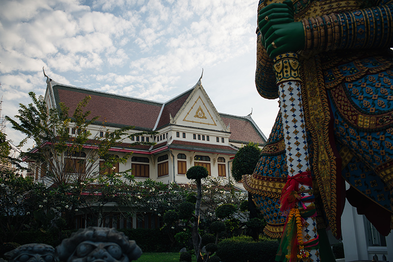 Temples of Bangkok Thailand, Wat Arun the Temple of Dawn garden and close up of guardian statue.