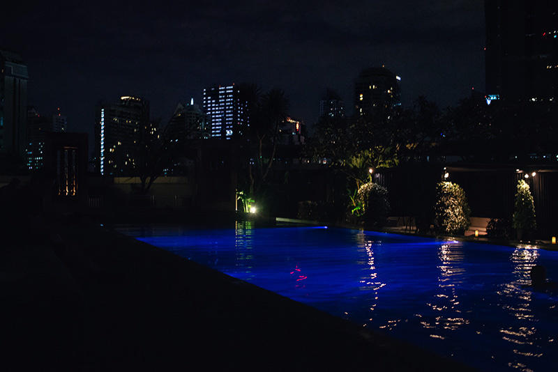Anantara Sathorn Bangkok hotel Thailand pool area at night.