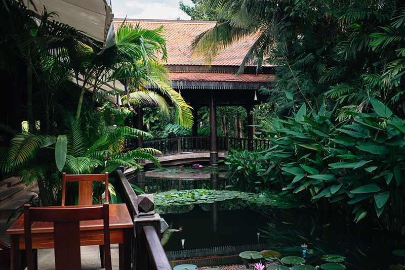 Sokhalay Angkor Villa Resort in Siem Reap Cambodia, dining area next to pond water with lily pads.