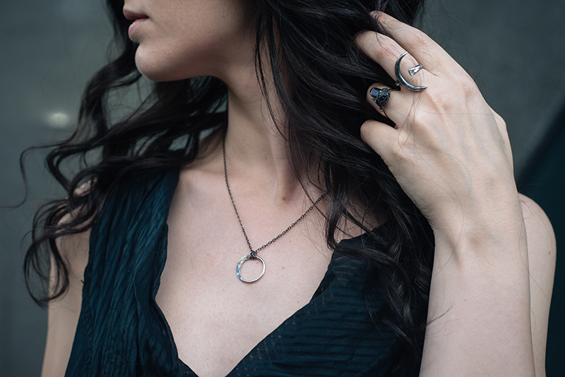 Fashion blogger Stephanie of FAIIINT wearing Wolf + Sadie Lucid Petite silver necklace and Theurgy claw ring, Elemental Luxury raw phantom quartz ring. All black outfit details.