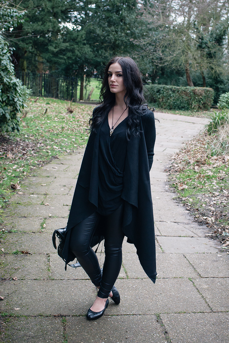 Fashion blogger Stephanie of FAIIINT wearing H&M Draped coat jacket, River Island draped top, New Look coated skinny jeans, Clarks ballet flats shoes, Sudio Sweden wireless headphones. All black everything goth dark street style outfit.