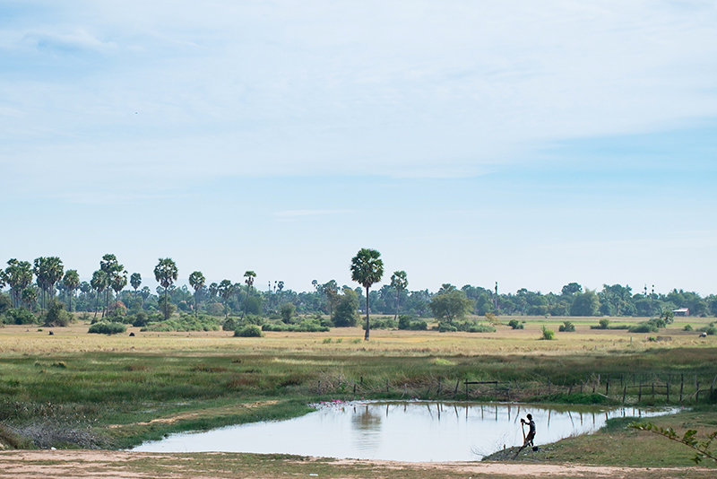 Motorbiking through the Siem Reap countryside in Cambodia lake and landscape.