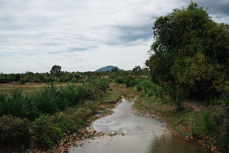 Countryside landscape in Siem Reap Cambodia, stream and views of Phnom Kulen mountain.