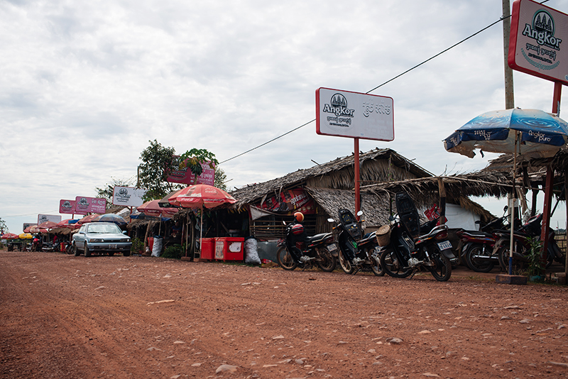 Motorbiking throught the Siem Reap countryside in Cambodia on a Honda Dream, roadside stop.