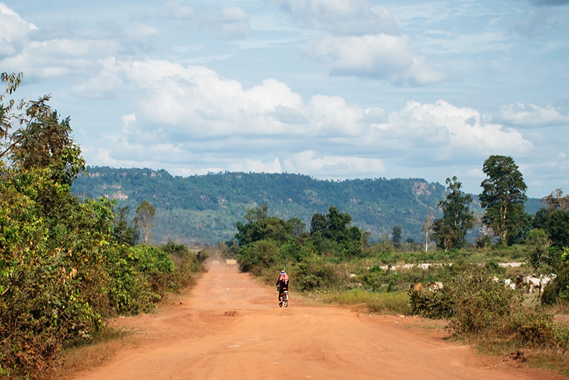 Countryside landscape in Siem Reap Cambodia, dusty sand roads and local on bike.