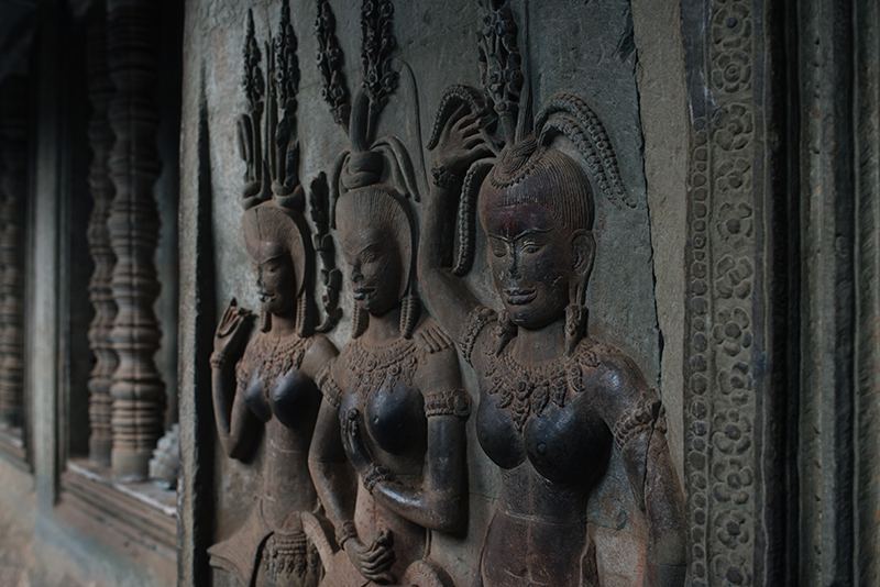 Details of carvings female dancers at Angkor Wat temple complex Siem Reap Cambodia.