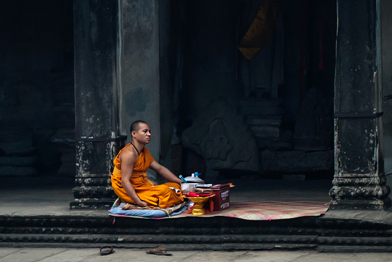 Monk at Angkor Wat temple complex Siem Reap Cambodia.