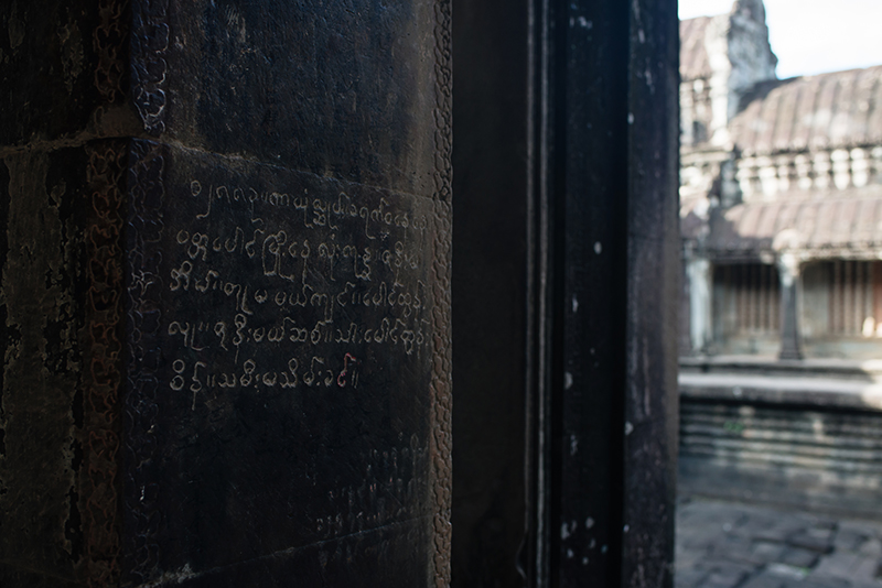 Close up detail of carving inscription Khmer script at Angkor Wat temple complex Siem Reap Cambodia.
