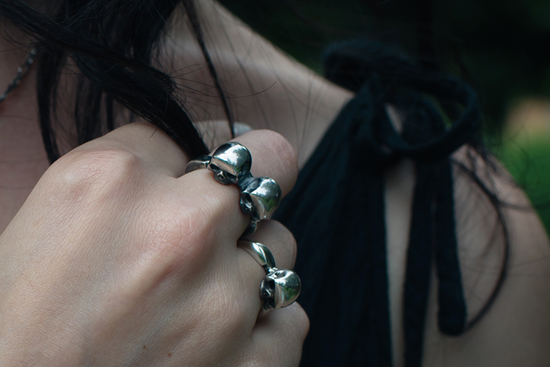 Fashion blogger Stephanie of FAIIINT wearing Toilworn silver single and double skull ring. All black dark style outfit details.