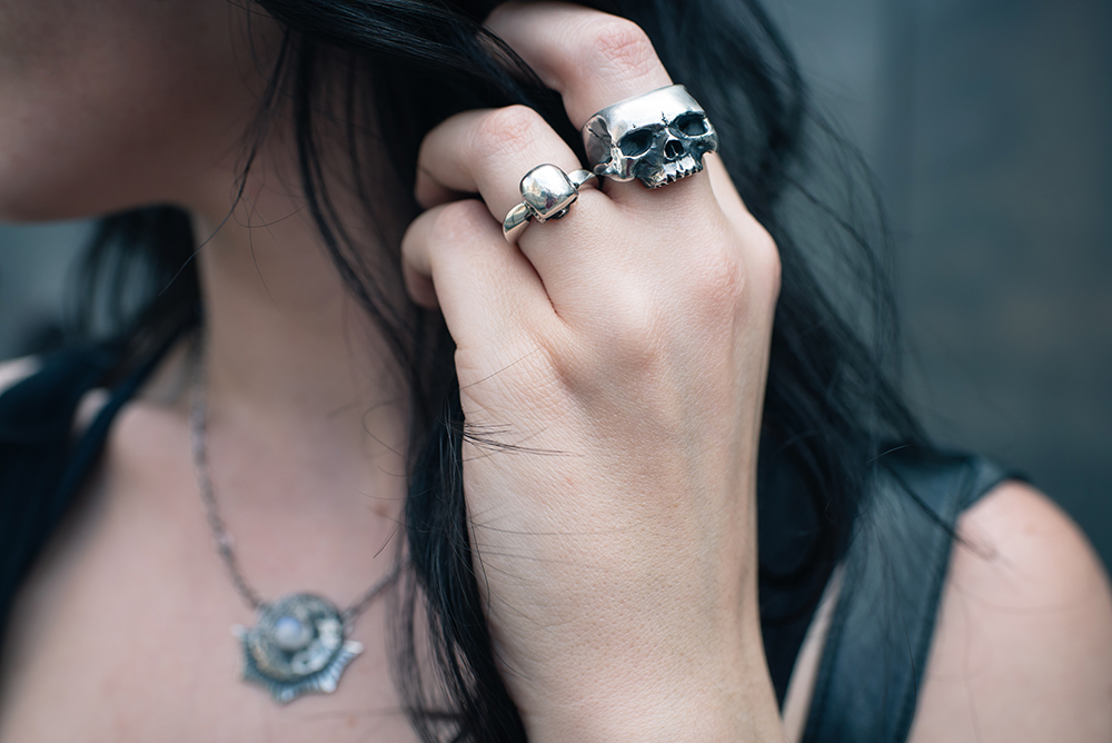 Fashion blogger Stephanie of FAIIINT wearing Toilworn jewellery large silver skull ring, mini skull ring and luna landing moon necklace. Goth outfit details.