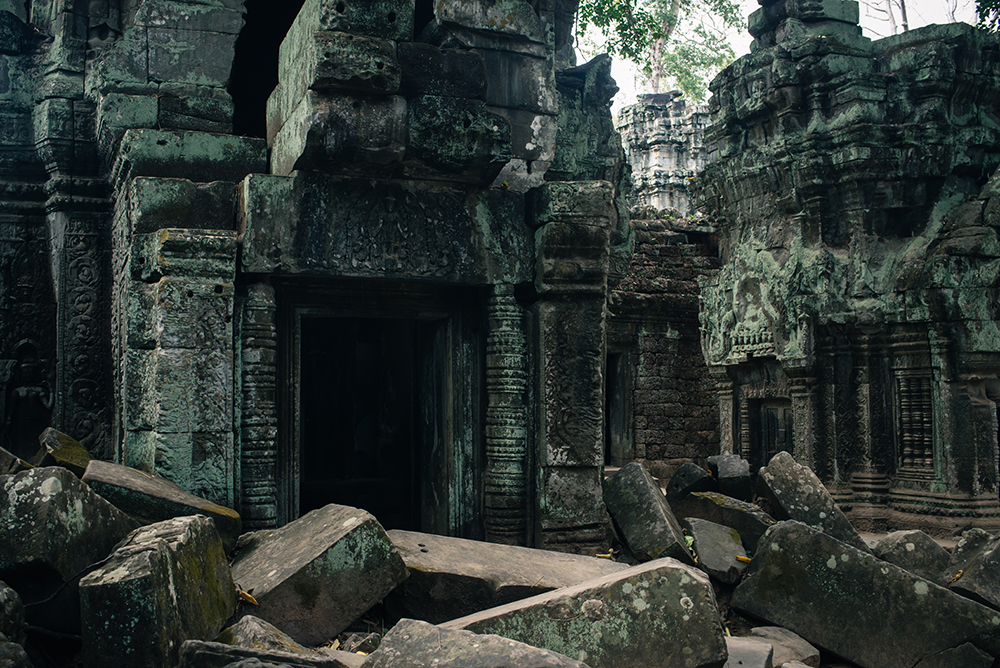 Ta Prohm temple Siem Reap Angkor Cambodia. Crumbling ruins reclaimed by nature and overgrown with trees and plants.