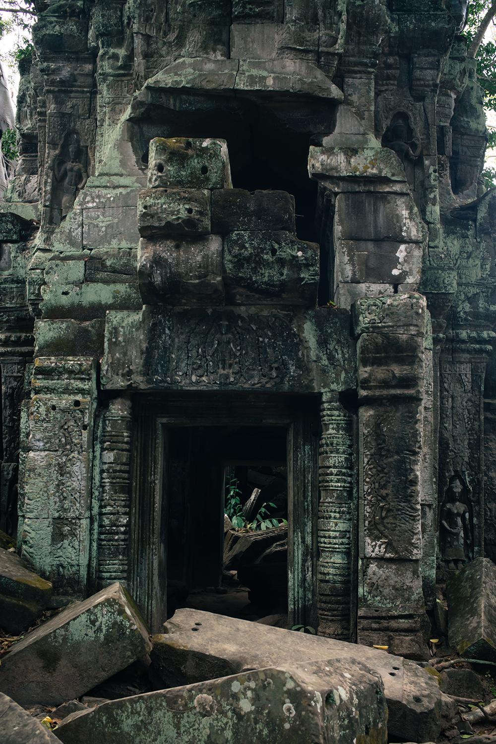 Ta Prohm temple doorway Siem Reap Angkor Cambodia. Crumbling ruins reclaimed by nature and overgrown with trees and plants.