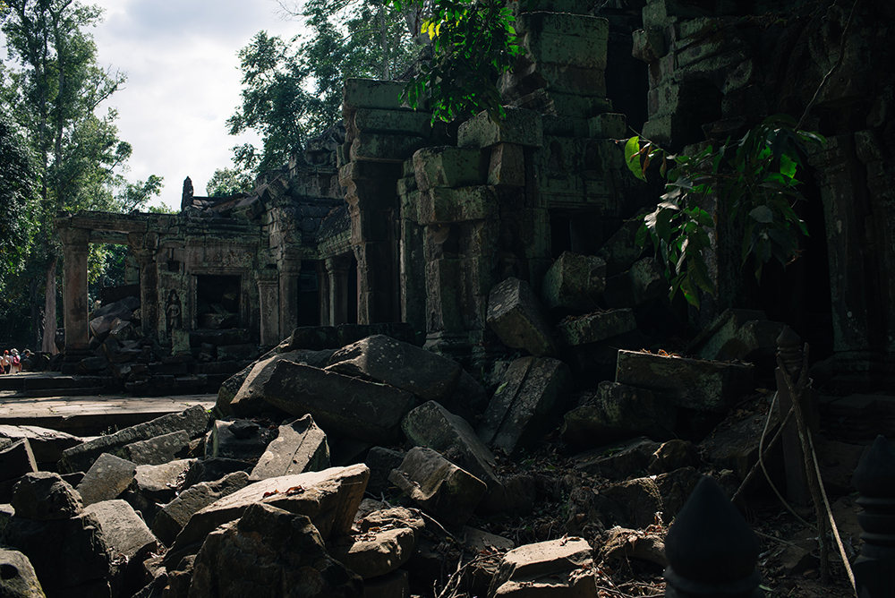 Ta Prohm temple Siem Reap Angkor Cambodia. Crumbling ruins reclaimed by nature and overgrown with trees and roots.