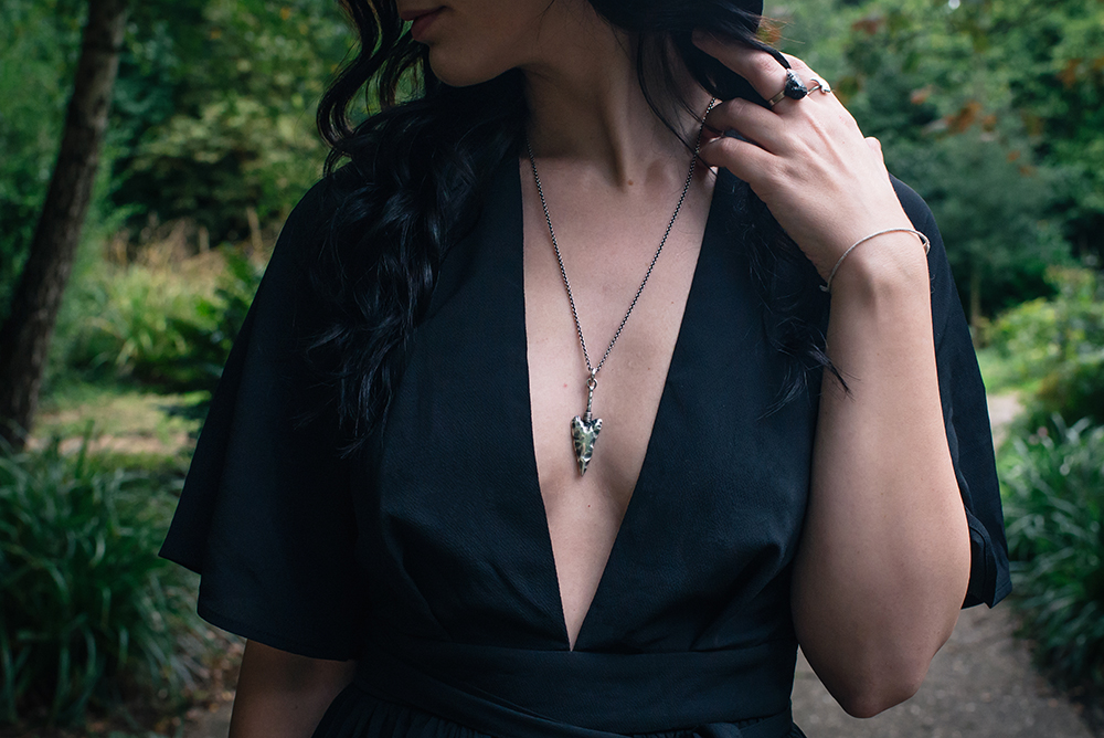 Fashion blogger Stephanie of FAIIINT wearing Toilworn jewellery silver arrowhead necklace and Elemental Luxury quartz ring. Witchy outfit details.