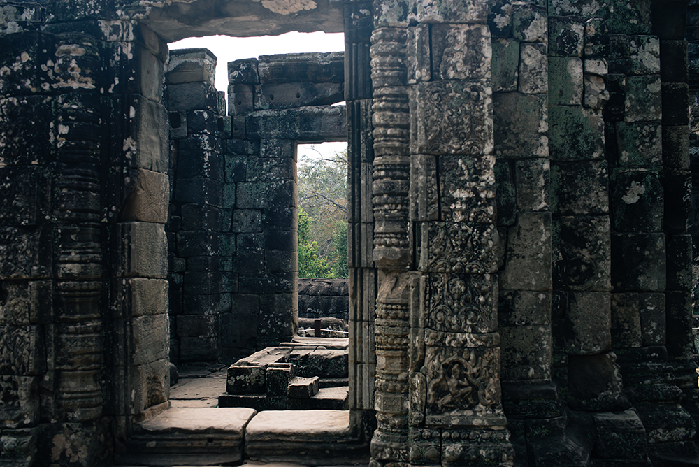 Bayon temple ruins Siem Reap Angkor Cambodia, room with no roof and detail carvings.
