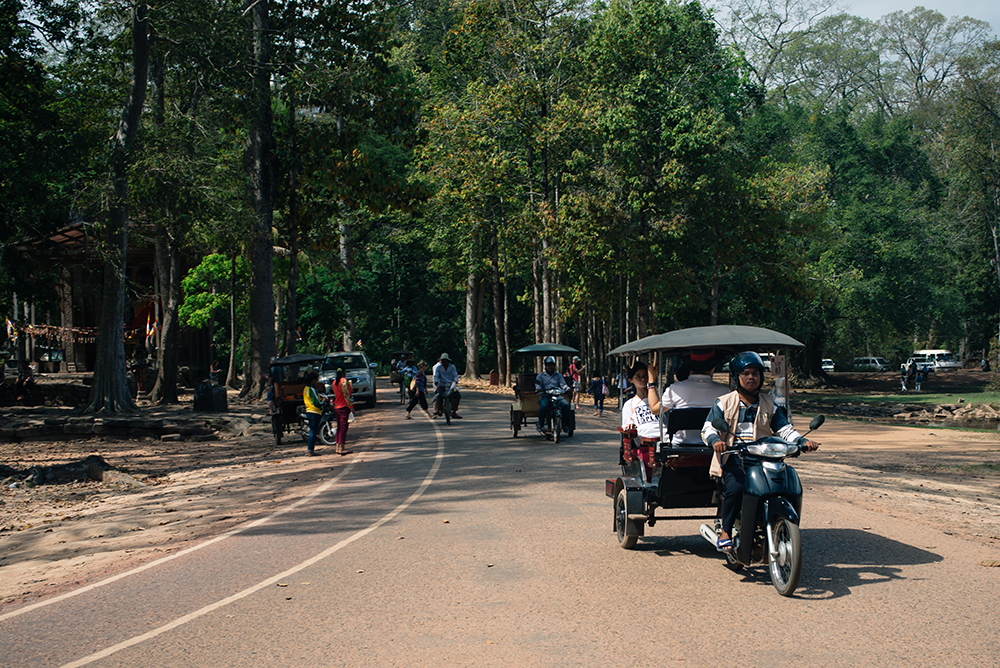 Bayon temple ruins Siem Reap Angkor Cambodia, tuk tuks.
