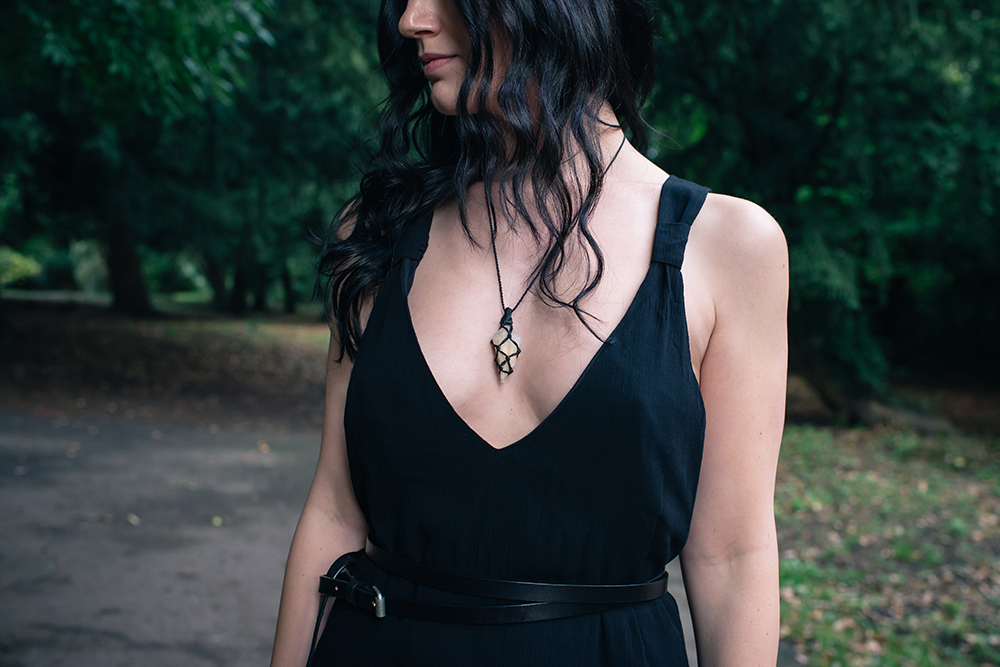 Fashion blogger FAIIINT wearing braided raw quartz necklace from Cambodian market, Tobi black summer dress. Outfit details.