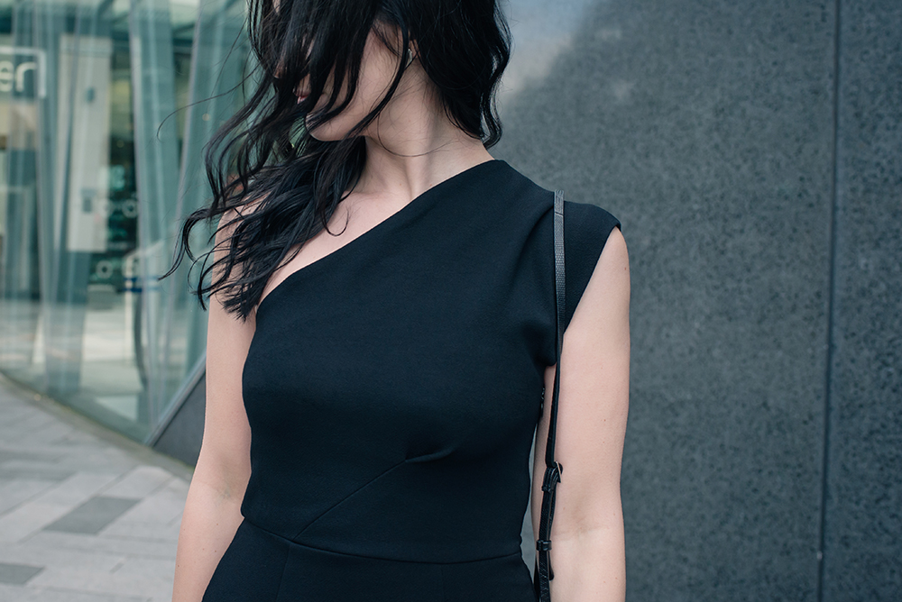 Fashion blogger Stephanie of FAIIINT wearing Reiss one shoulder asymmetric Keria dress. All black outfit details.