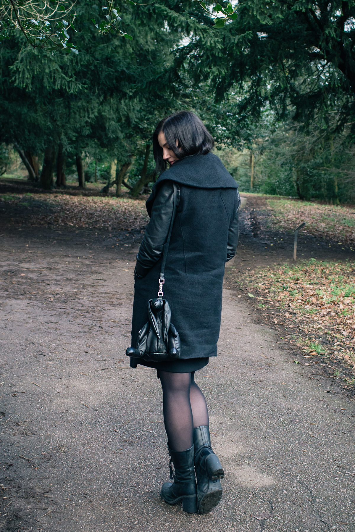 Fashion blogger Stephanie of FAIIINT wearing Helmut Lang Willowed wool and leather asymmetric coat, O.X.S. lace up boots, Christopher Raeburn Hare bag. All black dark style outfit.