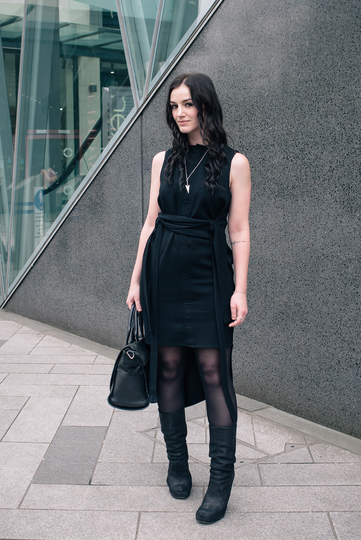 Dark fashion blogger Stephanie FAIIINT wearing House of Sunny dress with wrap belt, Rick Owens Wedge boots. All black outfit, dark street style.