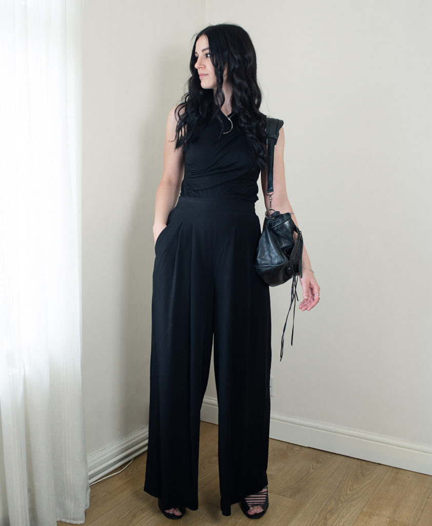 Fashion blogger FAIIINT wearing all black summer outfit with H&M wide leg trousers and Balenciaga city bag.