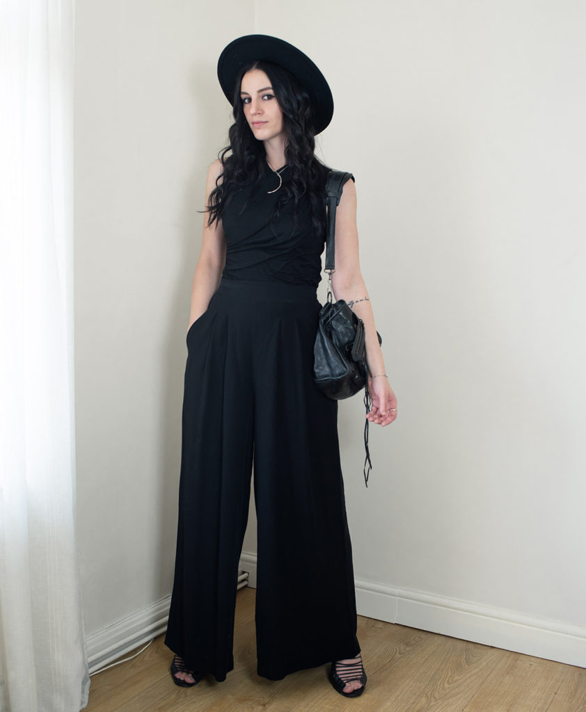 Fashion blogger FAIIINT wearing all black summer outfit with H&M wide leg trousers, black fedroa hat and Balenciaga city bag.