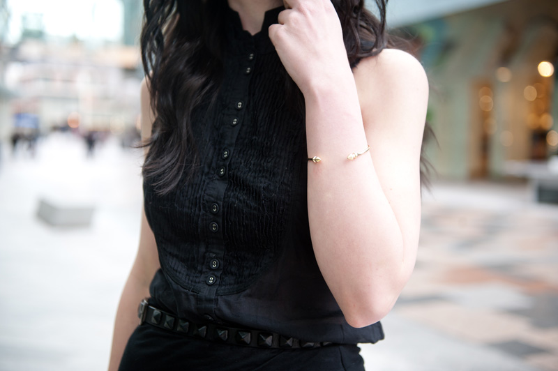 Fashion blogger Stephanie of FAIIINT wearing AllSaints Sleeveless Shirt, River Island Draped Asymmetric Skirt, Skin by Finsk Wedge Sandals, Topshop Studded Belt, ASOS Spiked Bangle, Balenciaga City bag. All black, dark, gothic, street style.