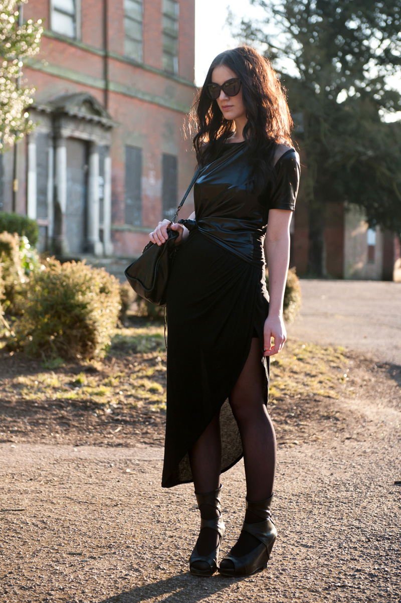 Fashion blogger Stephanie Brown of FAIIINT wearing MeeMee wet look cut out tee, River Island asymmetric skirt, Rick Owens wedges, Balenciaga city, AllSaints cateye sunglasses. Spring Summer gothic street style. All Black.