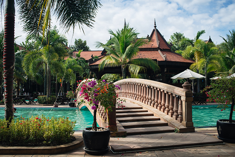 Sokhalay Angkor Villa Resort in Siem Reap Cambodia, tropical pool with flowers and bridge.
